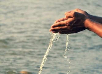 person holding water splash during daytime